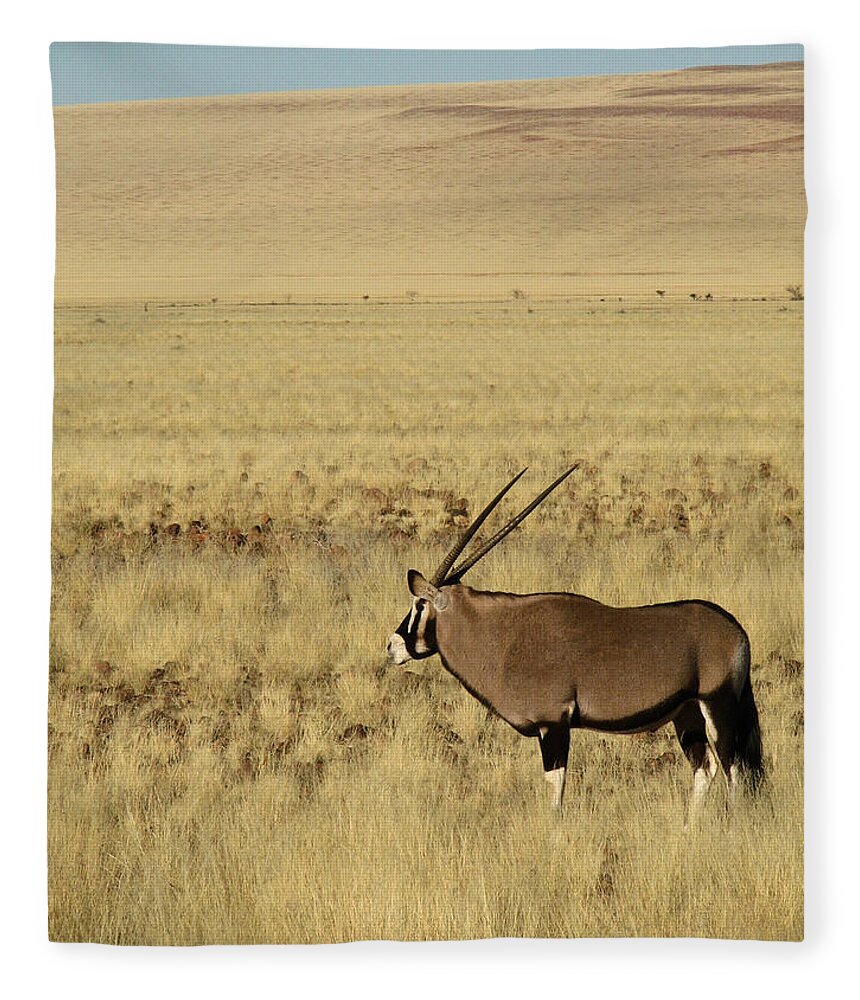 Grass Fleece Blanket featuring the photograph A Lone Oryx by Elne Burgers