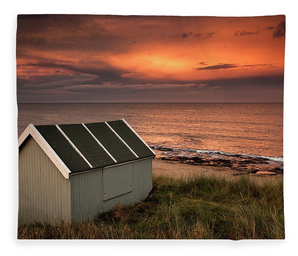 Water's Edge Fleece Blanket featuring the photograph A Small Building On The Waters Edge At by John Short / Design Pics