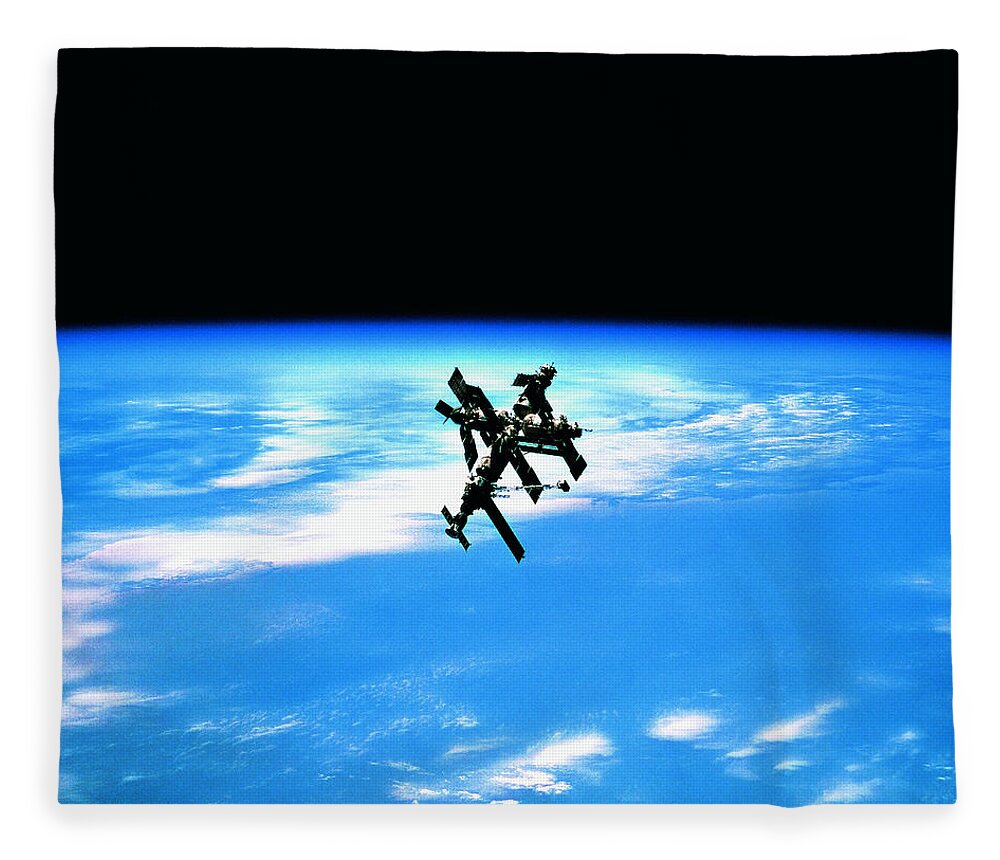 Research Fleece Blanket featuring the photograph A Space Station In Orbit Above Earth by Stockbyte