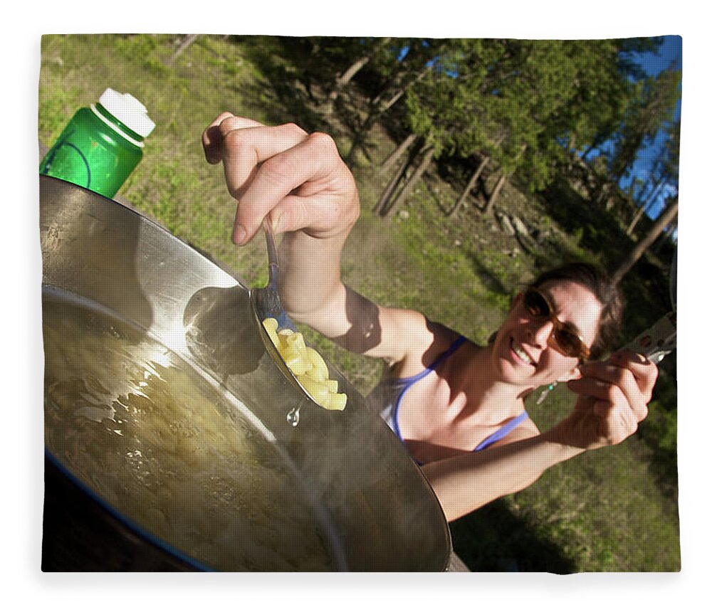 Camping Fleece Blanket featuring the photograph A Young Woman Cooks Her Macaroni Dinner by Derek Diluzio
