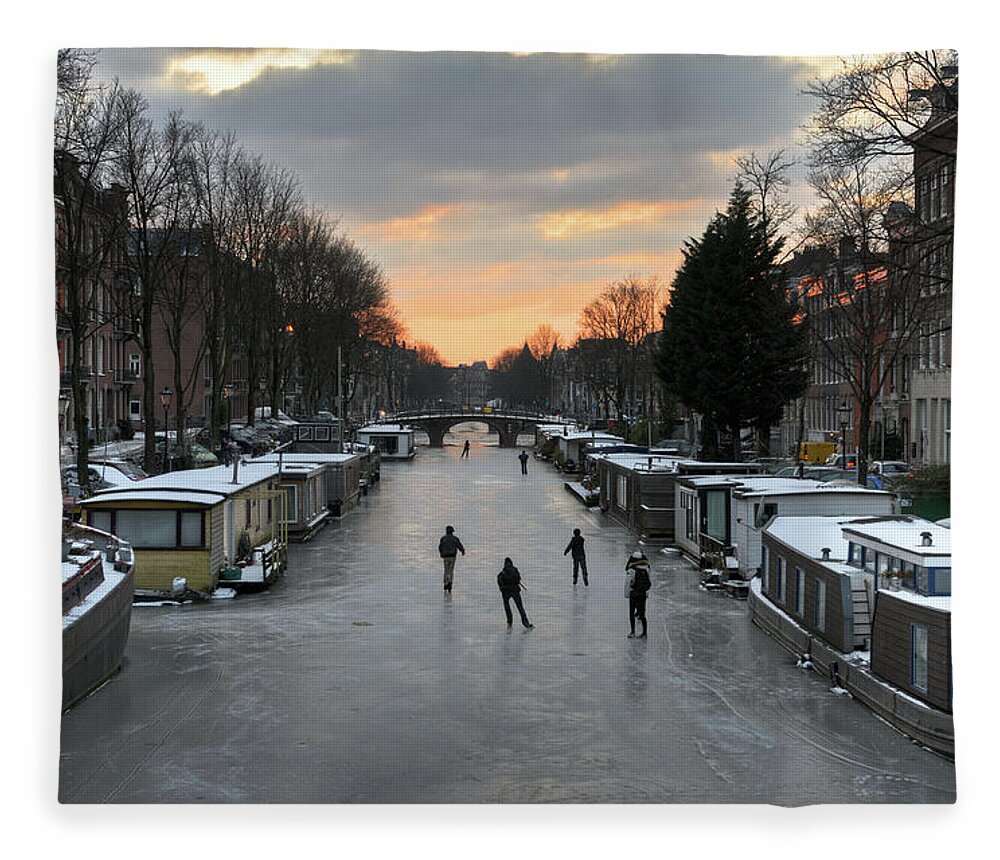 North Holland Fleece Blanket featuring the photograph Amsterdam Canal Ice Skating by Roevin