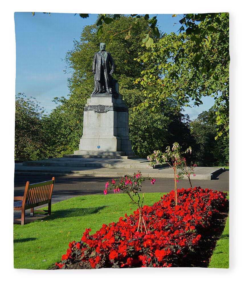 Flowerbed Fleece Blanket featuring the photograph Carnegie Statue, Dunfermline by Dennis Barnes
