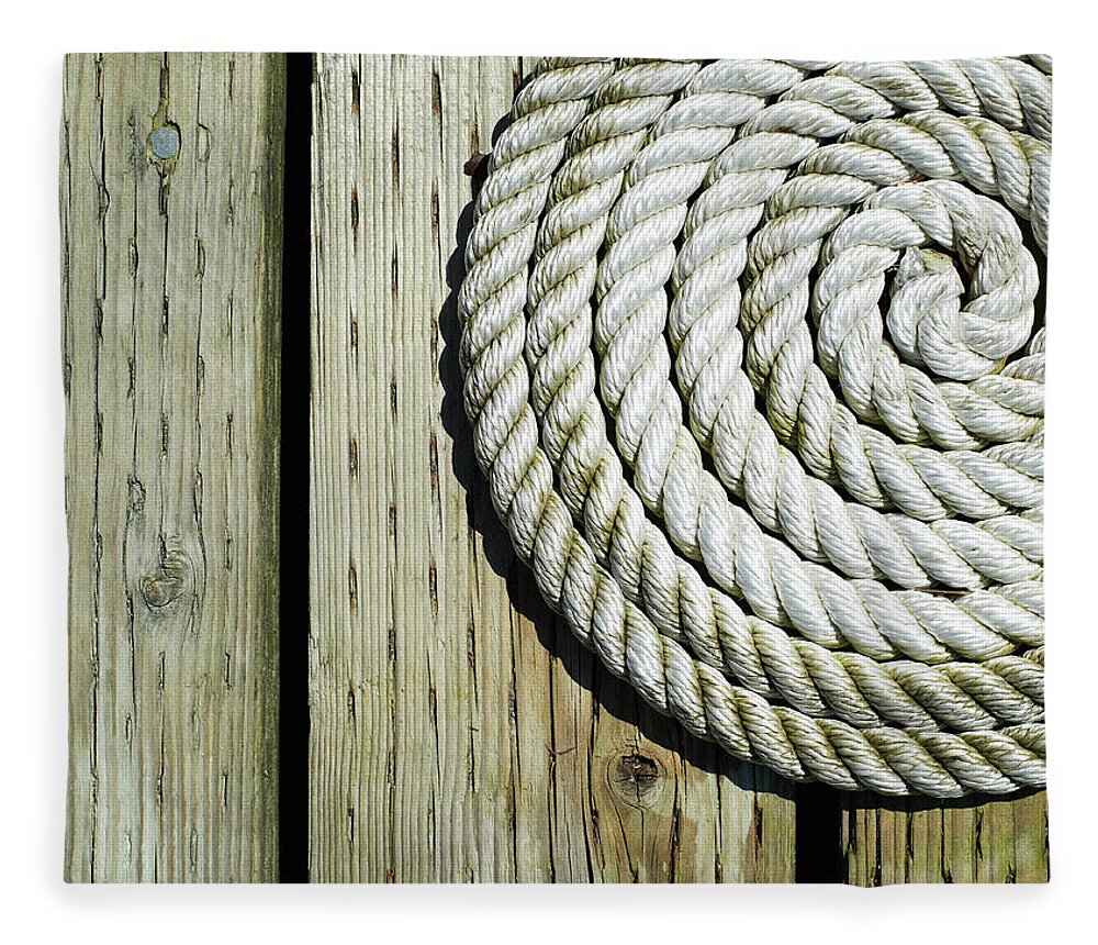 Part Of A Series Fleece Blanket featuring the photograph Coiled Rope On Dock by Ryan Mcvay