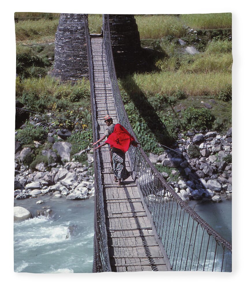 Nepal Fleece Blanket featuring the photograph Crossing a suspension bridge by Steve Estvanik