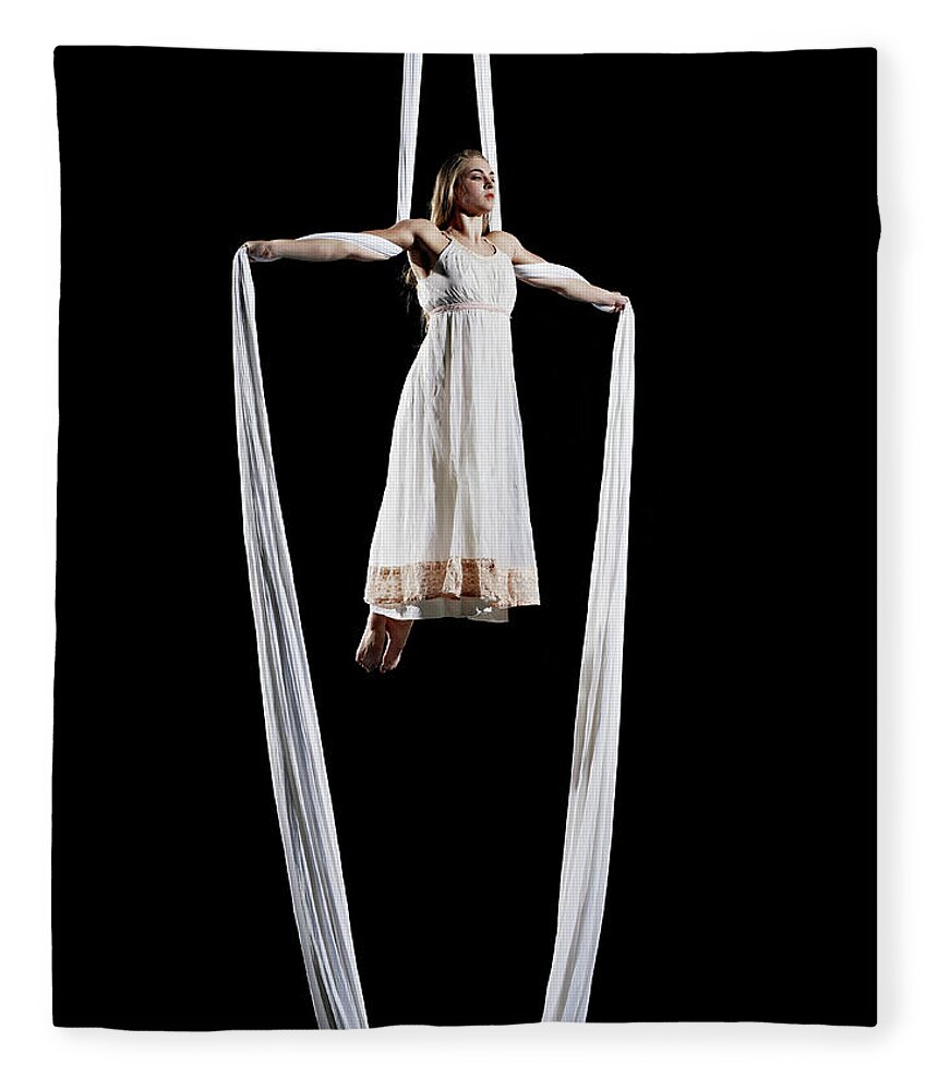 Expertise Fleece Blanket featuring the photograph Female Aerialist Performing On by Thomas Barwick