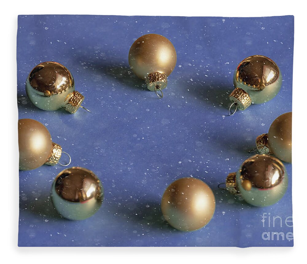 Decoration Fleece Blanket featuring the photograph Golden christmas balls on the snowy background by Marina Usmanskaya