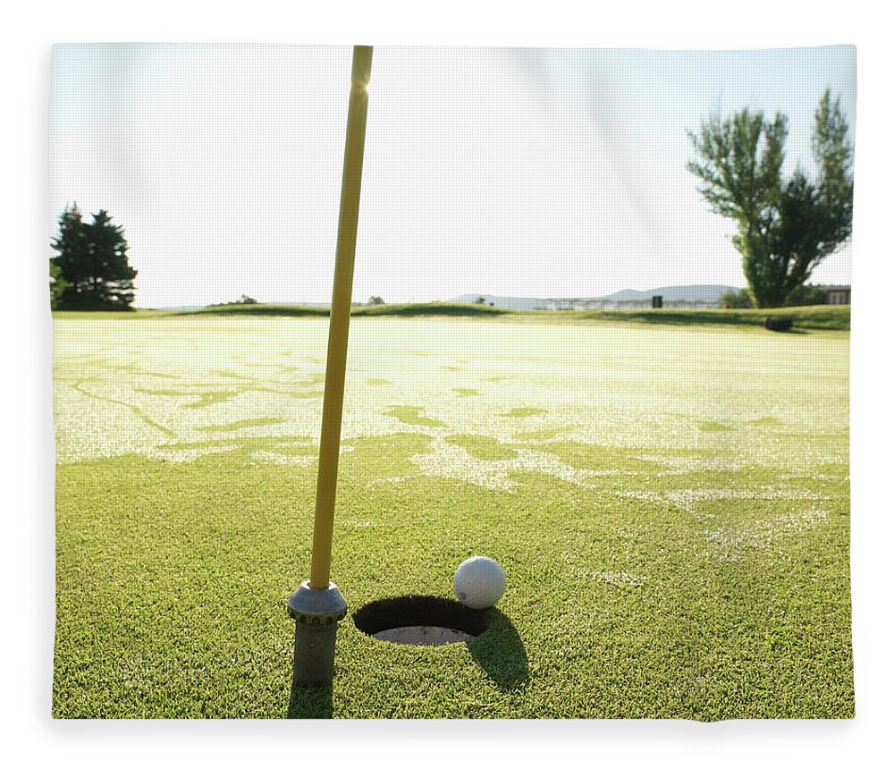 Grass Fleece Blanket featuring the photograph Golf Ball Near Hole At Sunrise, High by Ascent/pks Media Inc.