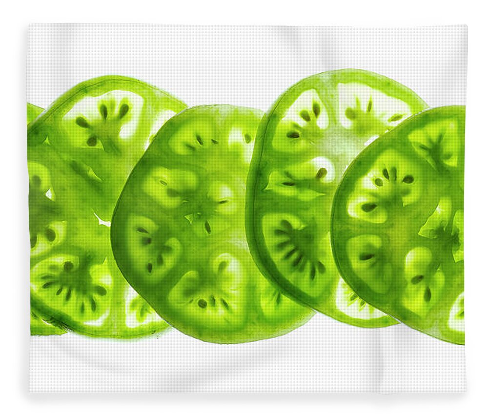 Five Objects Fleece Blanket featuring the photograph Green Tomato Slices On A White by Howard Bjornson