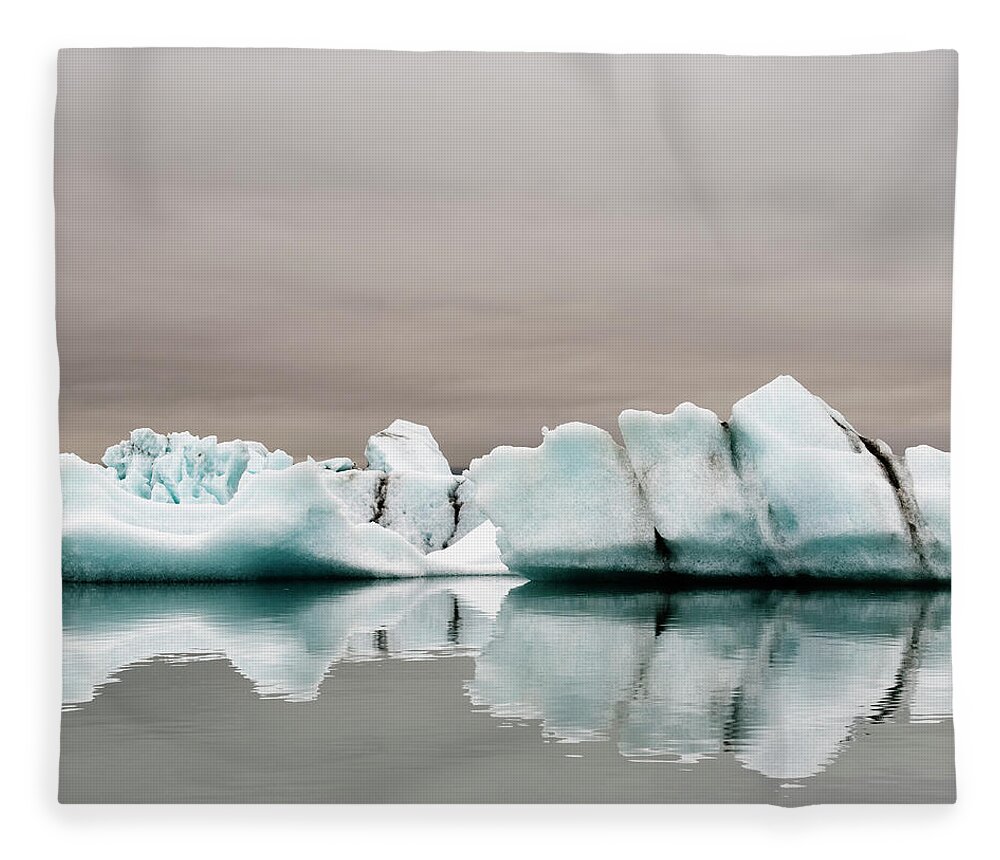 Glacier Lagoon Fleece Blanket featuring the photograph Iceberg In Water by Roine Magnusson
