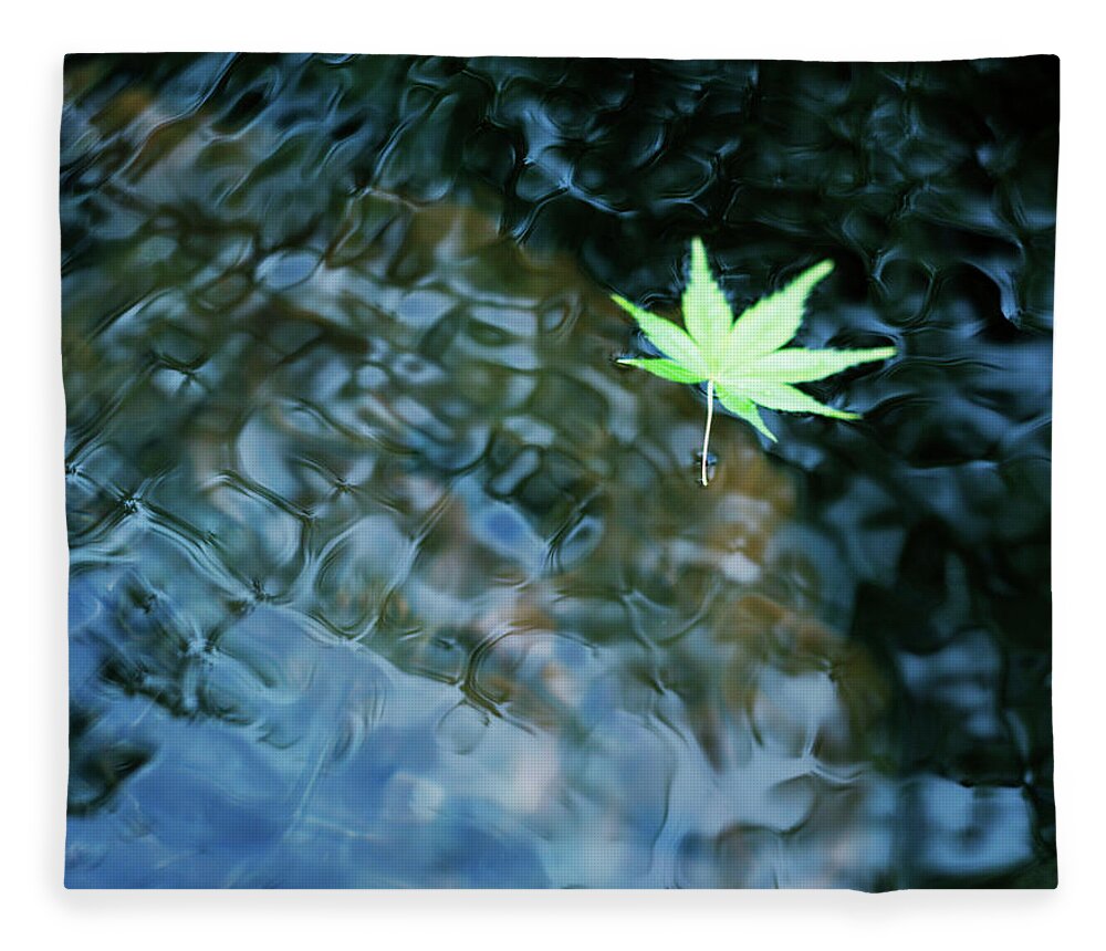 Tranquility Fleece Blanket featuring the photograph Leaf Floating On Water by Bloom Image