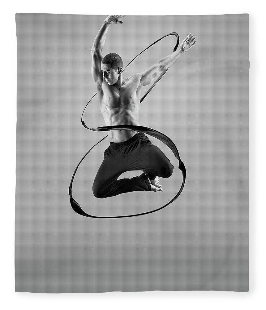 Human Arm Fleece Blanket featuring the photograph Male Athlete Jumping In Liquid Splsh by Jonathan Knowles