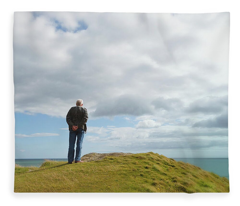 Tranquility Fleece Blanket featuring the photograph Man Standing Alone On A Hill Staring At by Ken Welsh / Design Pics