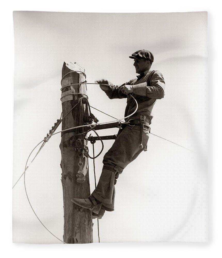 People Fleece Blanket featuring the photograph Man Worker, Working Atop Utility Pole by H. Armstrong Roberts