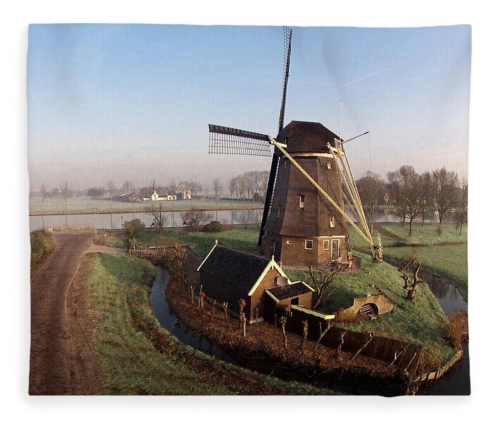 North Holland Fleece Blanket featuring the photograph Old Dutch Windmill Near Amsterdam by Photo By Fabfoto