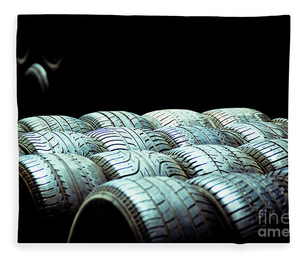 Abandoned Fleece Blanket featuring the photograph Old tires and racing wheels stacked in the sun by Joaquin Corbalan
