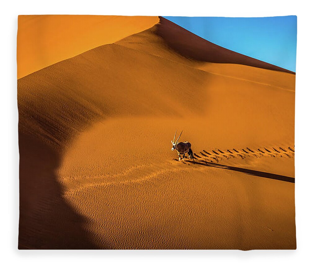 Dune Fleece Blanket featuring the photograph Oryx crossing big daddy dune, Sossusvlei, Namibia by Lyl Dil Creations