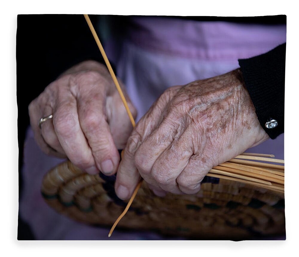 Knitting Fleece Blanket featuring the photograph Senior woman knitting a traditional basket with reeds  by Michalakis Ppalis