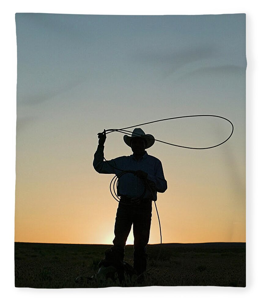 Dawn Fleece Blanket featuring the photograph Silhouette Of Cowboy With Lasso by Edward Mccain
