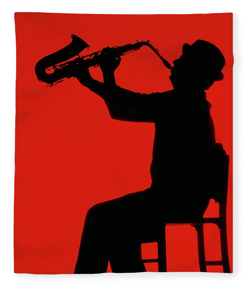 One Man Only Fleece Blanket featuring the photograph Silhouette Of Man Playing Saxophone by Grant Faint