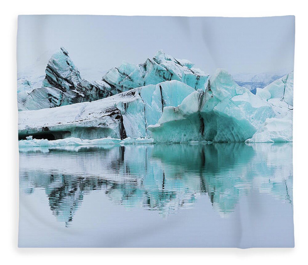 Tranquility Fleece Blanket featuring the photograph Silt-streaked Icebergs At Jökulsárlón by Anna Gorin