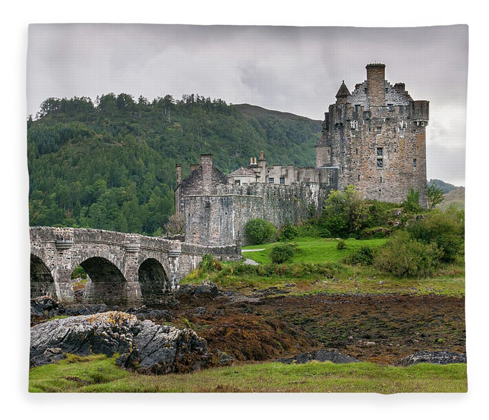Eilean Donan Fleece Blanket featuring the photograph The famous Eilean Donan Castle in the lake of Loch Alsh at the by Michalakis Ppalis