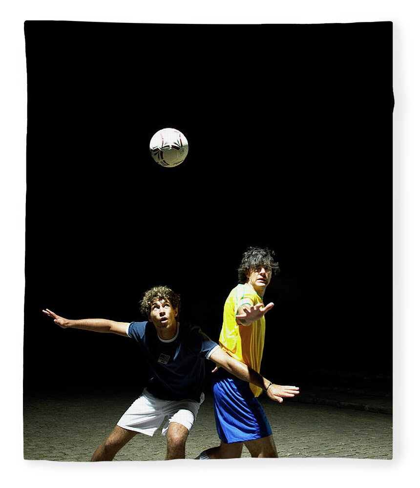 Young Men Fleece Blanket featuring the photograph Two Soccer Players Heading Ball, Night by Hans Neleman
