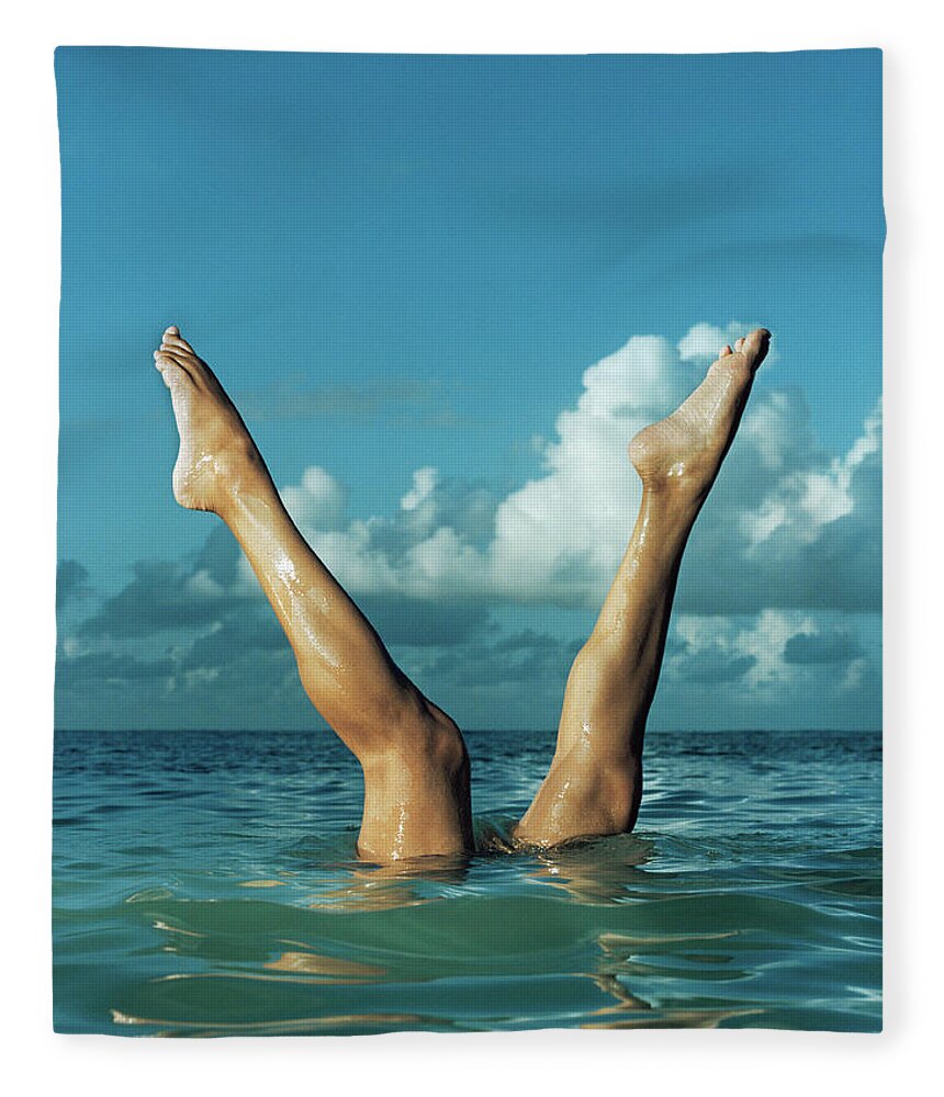 Diving Into Water Fleece Blanket featuring the photograph Woman Stretching Legs From Water by Matthias Clamer