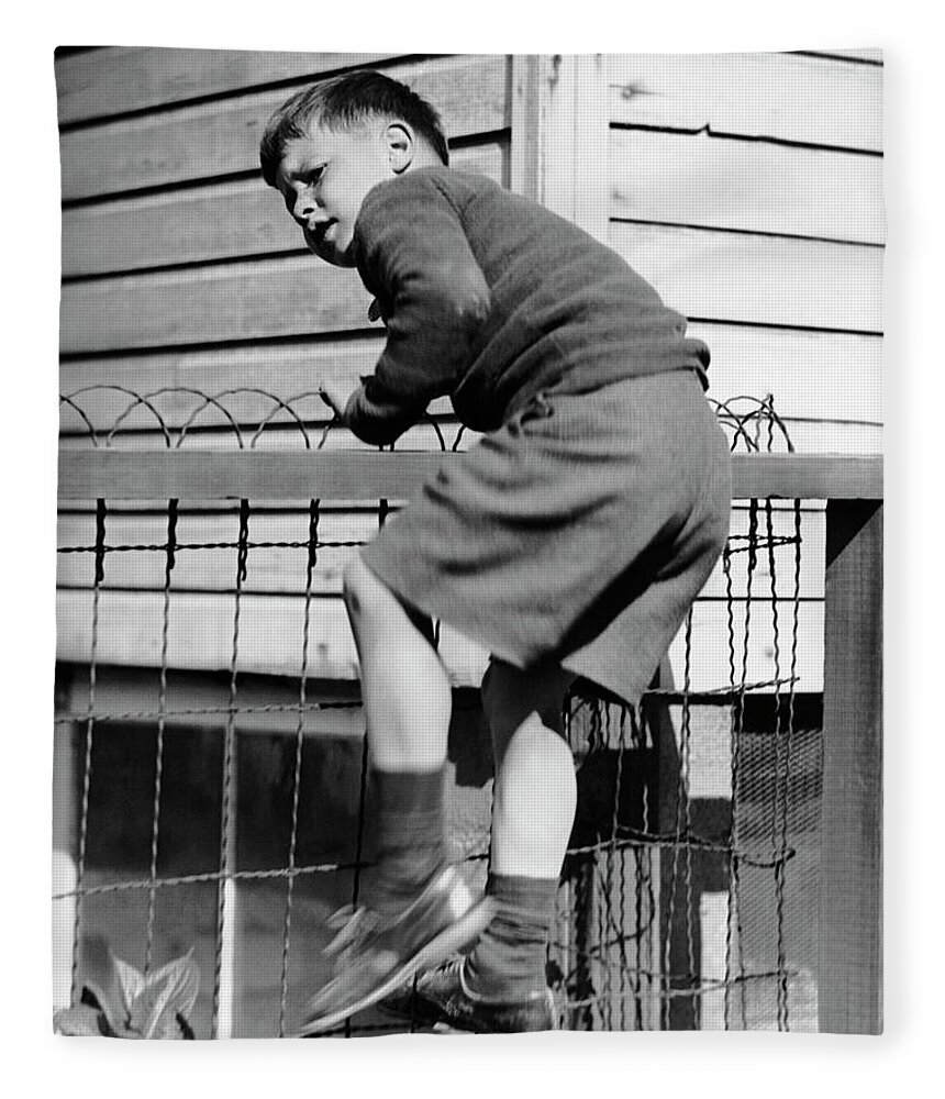 Child Fleece Blanket featuring the photograph Young Boy Climbing Fence by George Marks