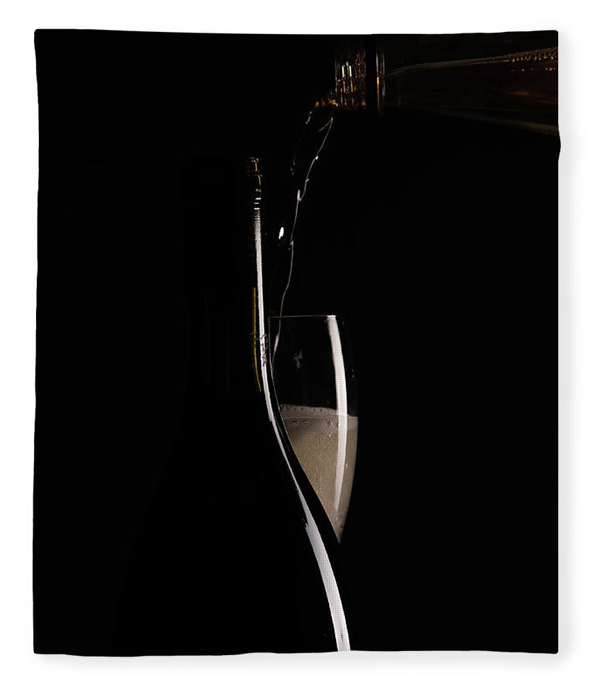 Red Wine Fleece Blanket featuring the photograph Red sparking wine on a wineglass and black wine bottle. #1 by Michalakis Ppalis