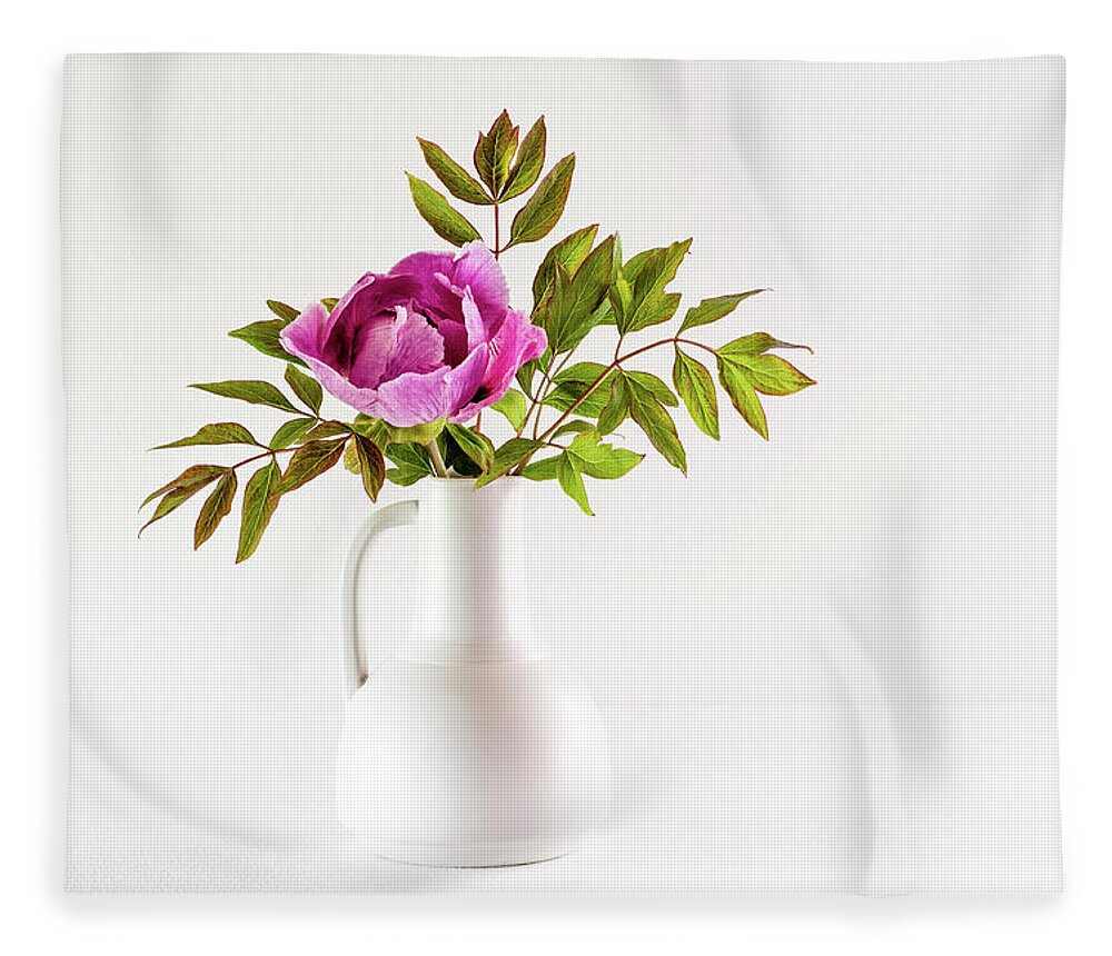 Tree Peony Fleece Blanket featuring the photograph Tree peony Lan He Paeonia suffruticosa rockii in a white vase by Torbjorn Swenelius