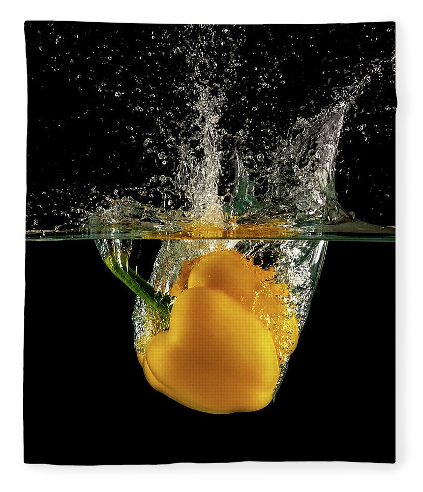 Pepper Fleece Blanket featuring the photograph Yellow bell pepper dropped and slashing on water by Michalakis Ppalis