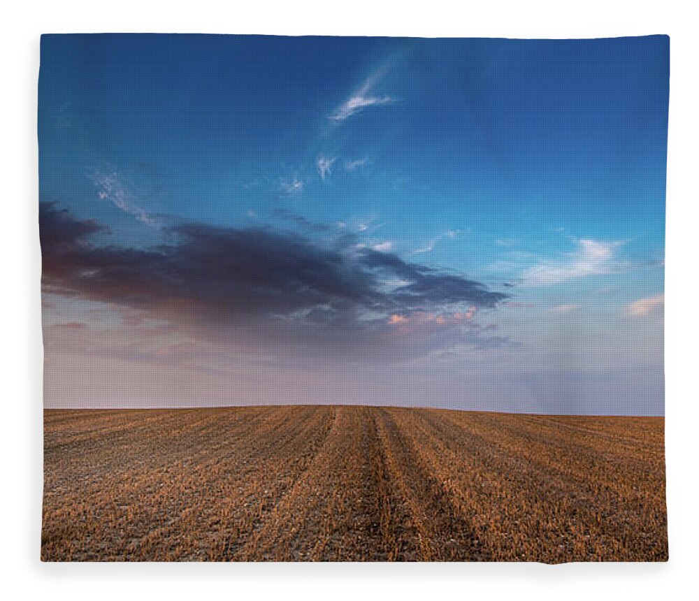 Nightfall Fleece Blanket featuring the photograph Agricultural meadow field and cloudy sky during sunset. by Michalakis Ppalis