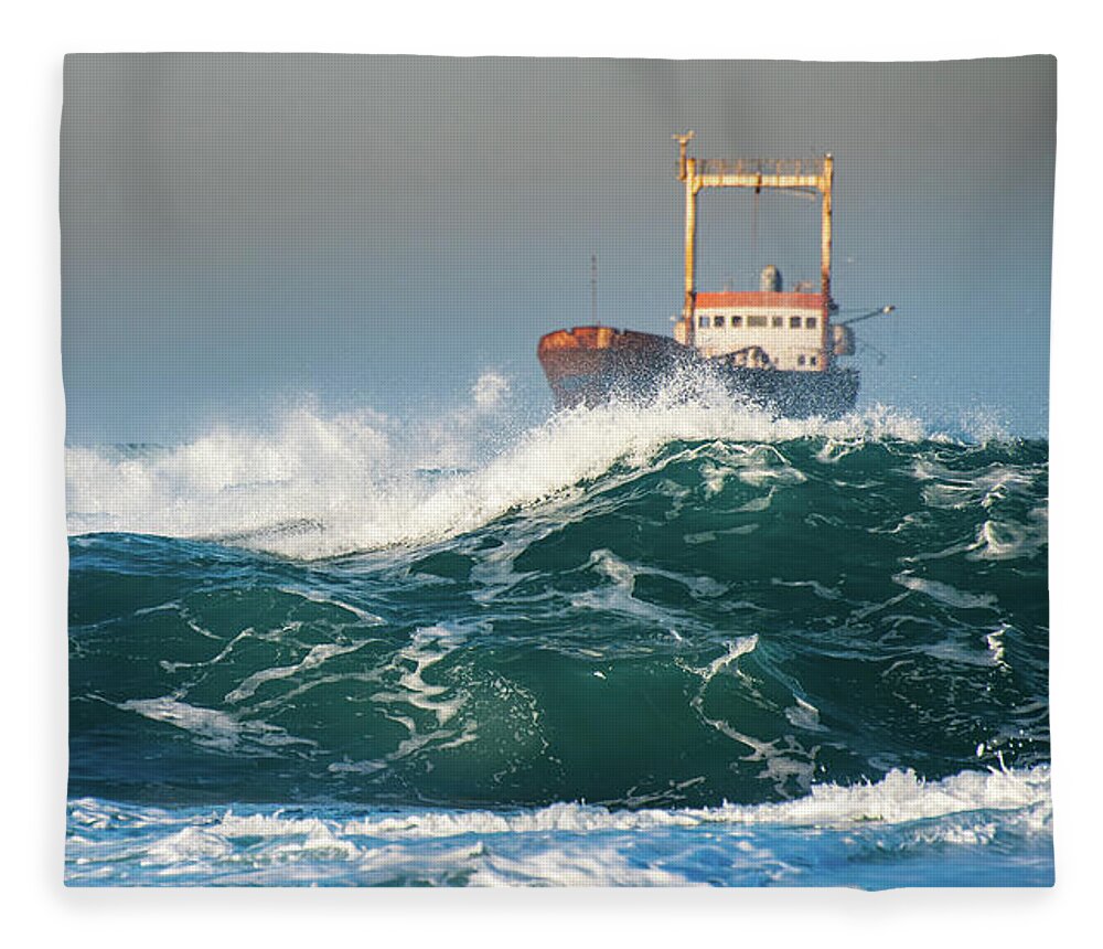 Shipwreck Fleece Blanket featuring the photograph Abandoned ship in the stormy ocean by Michalakis Ppalis
