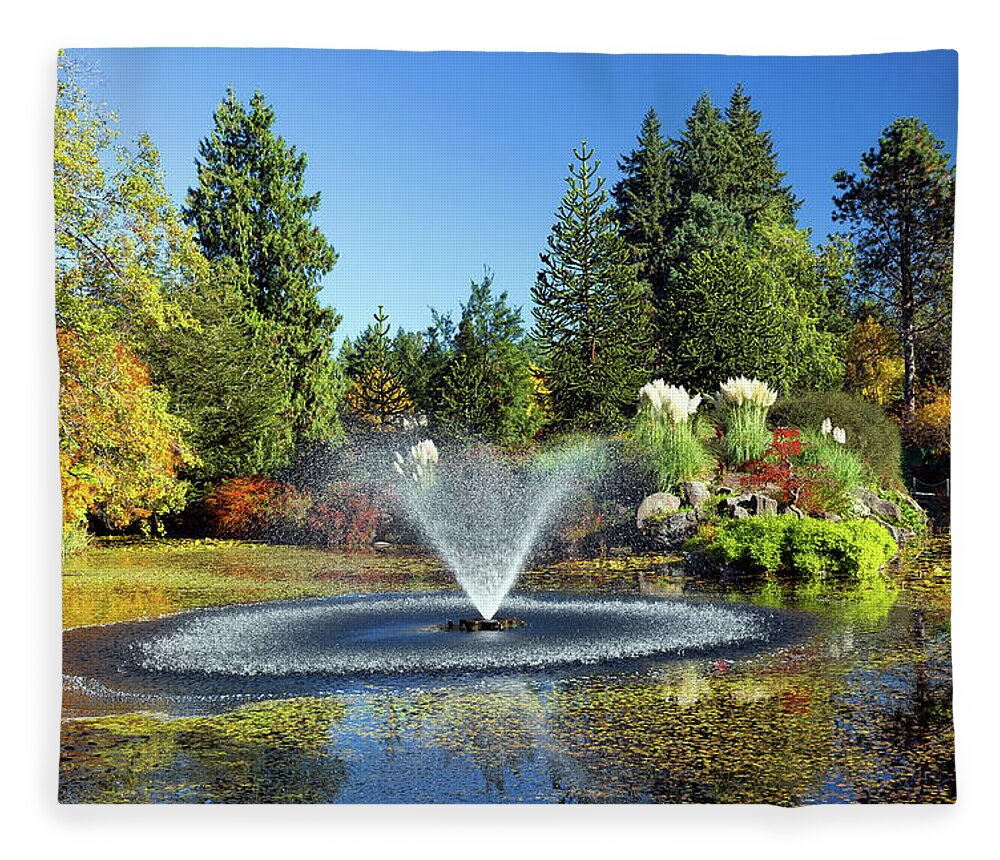 Alex Lyubar Fleece Blanket featuring the photograph Beautiful pond with fountain by Alex Lyubar