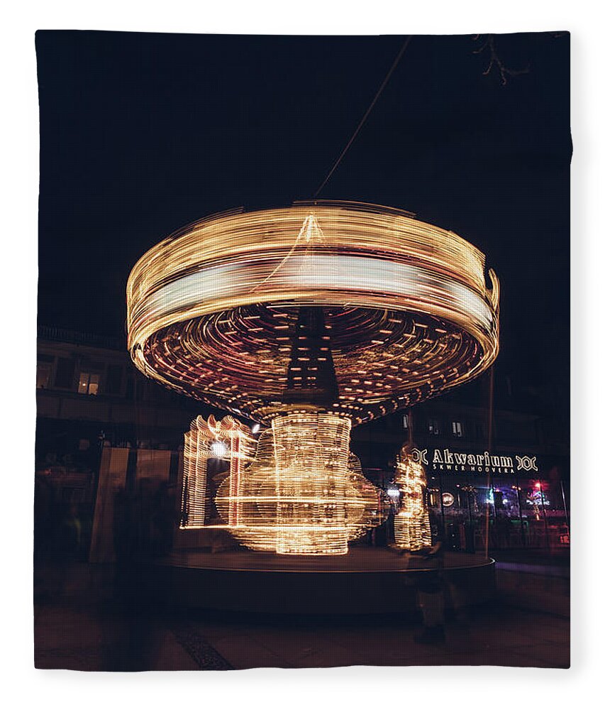 Illuminations Fleece Blanket featuring the photograph Christmas carousel on the streets of Warsaw. Fire Wheel by Vaclav Sonnek