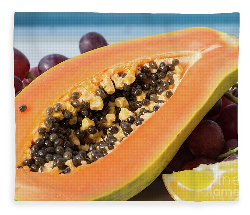 Papaya Fleece Blanket featuring the photograph Sweet taste of papaya and grapes by the pool by Adriana Mueller
