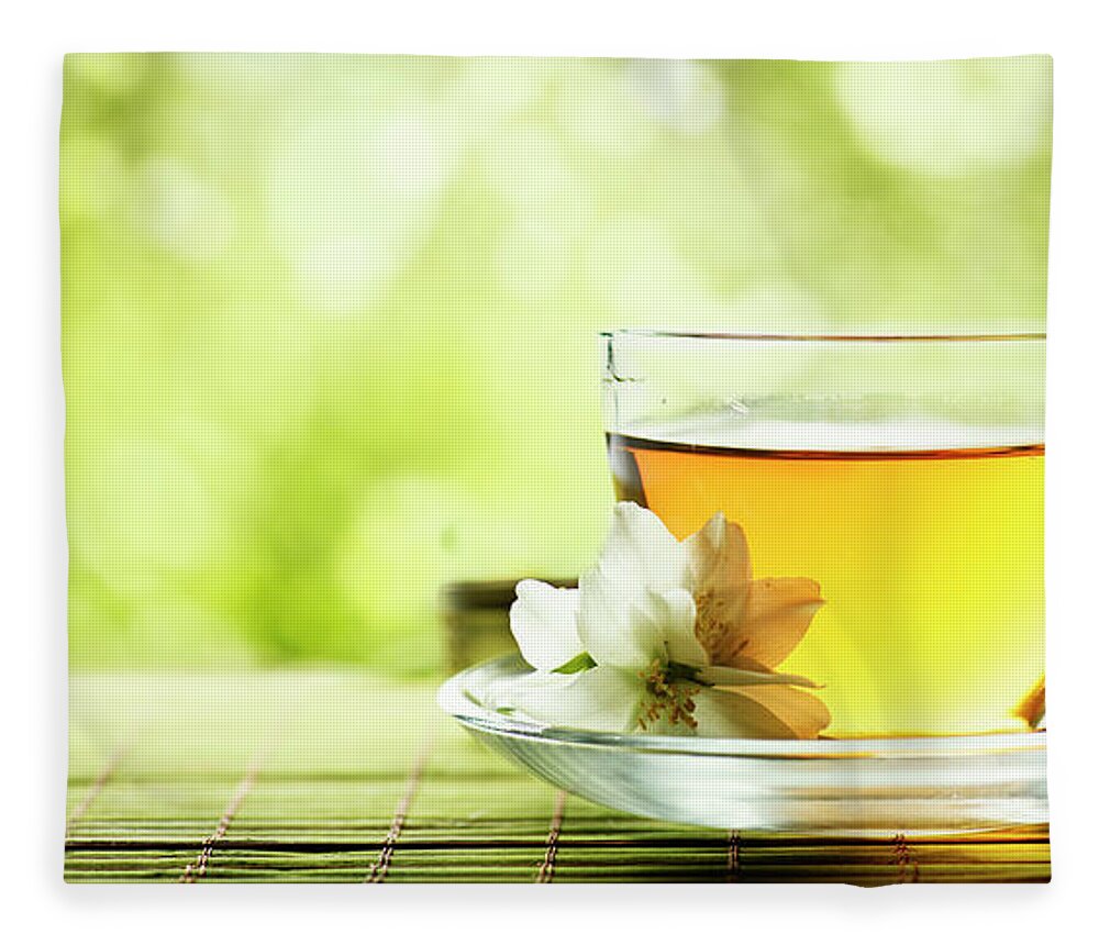 Tea Fleece Blanket featuring the photograph Herbal cup of tea on wooden table by Jelena Jovanovic