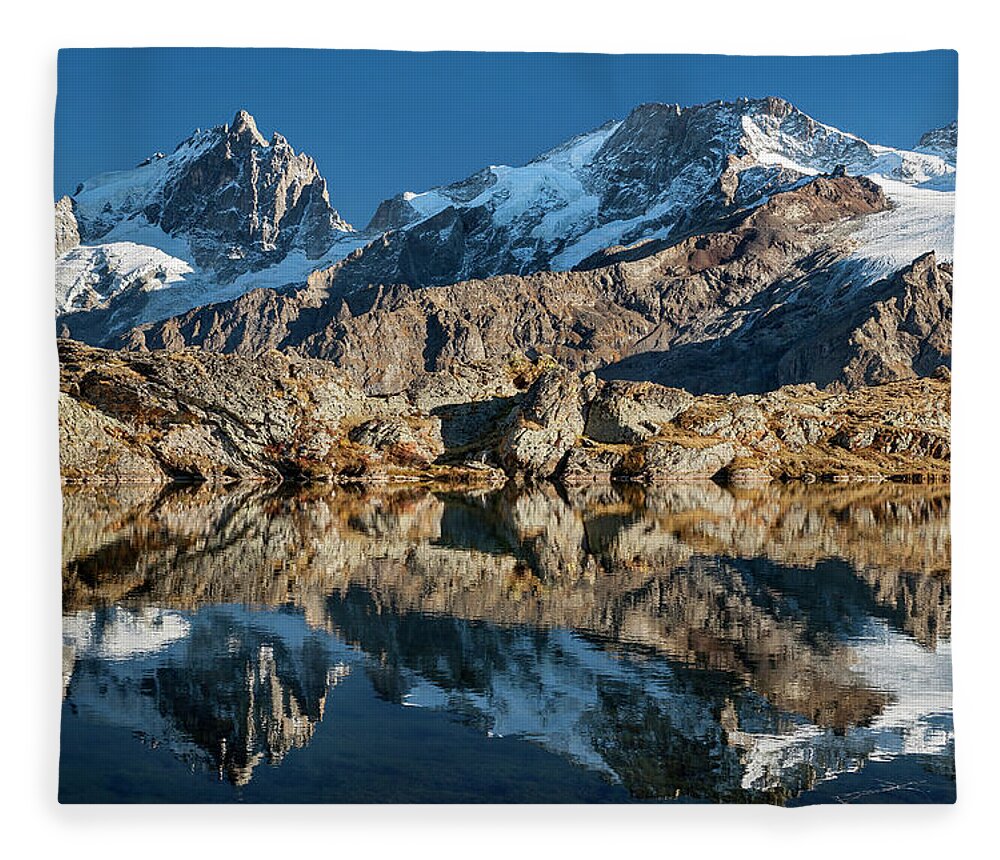 Lake Fleece Blanket featuring the photograph La Meije peak mirrored in Lake Lerie by Olivier Parent