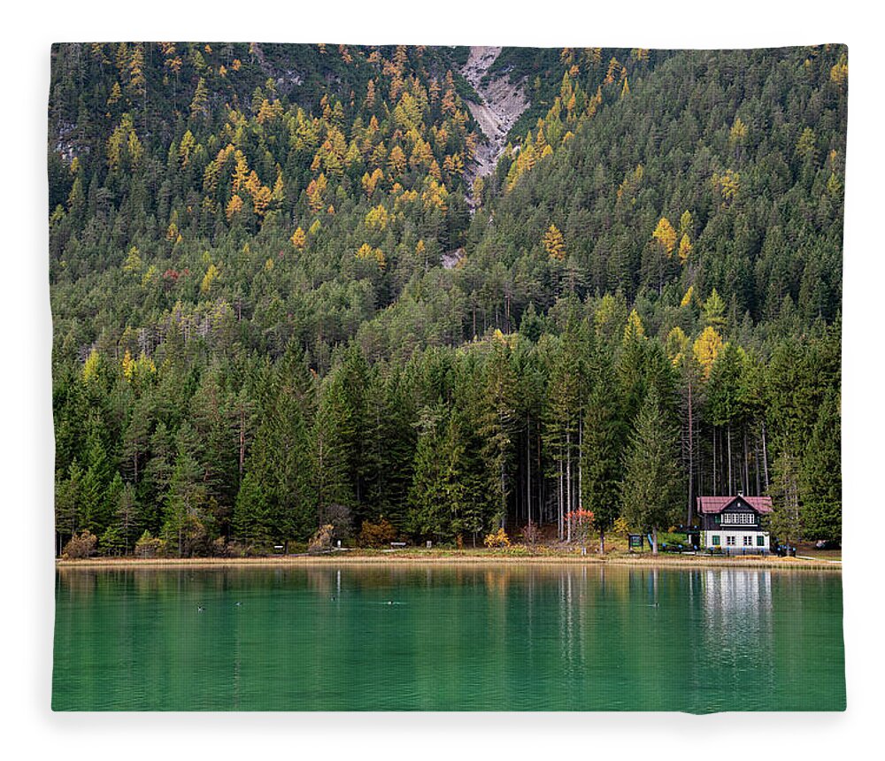Italy Fleece Blanket featuring the photograph House in the lake and forest. Lago di dobbiaco lake. Italian aps by Michalakis Ppalis