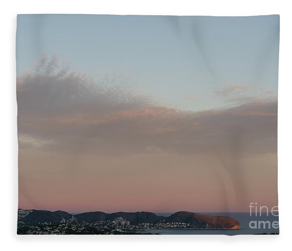 Mediterranean Coast Fleece Blanket featuring the photograph Pale pink sky and soft clouds at sunset on the Mediterranean coast by Adriana Mueller