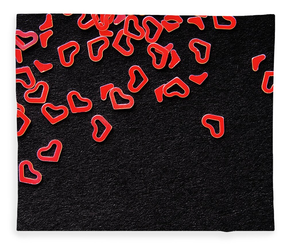 Confetti Fleece Blanket featuring the photograph Red Heart Confetti On Black Background by Severija Kirilovaite