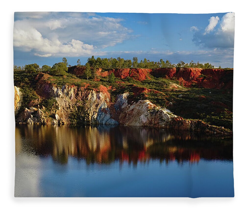 Alentejo Fleece Blanket featuring the photograph Reflections on the water pit in the abandoned mine of Sao Domingos. Portugal by Angelo DeVal