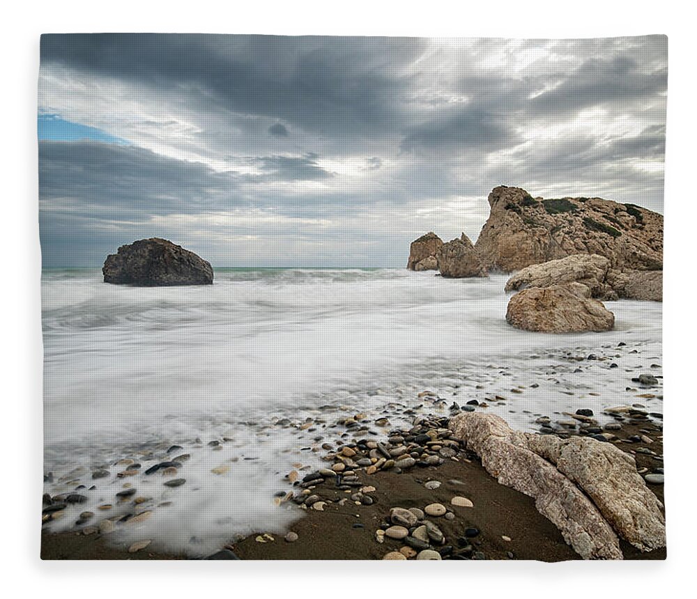 Seascape Fleece Blanket featuring the photograph Seascape with windy waves splashing at the rocky coastal area. by Michalakis Ppalis