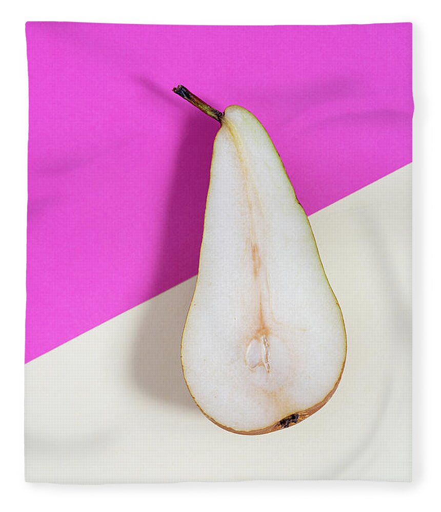 Still-life Fleece Blanket featuring the photograph Slice of healthy pear fruit on a colourful background. by Michalakis Ppalis