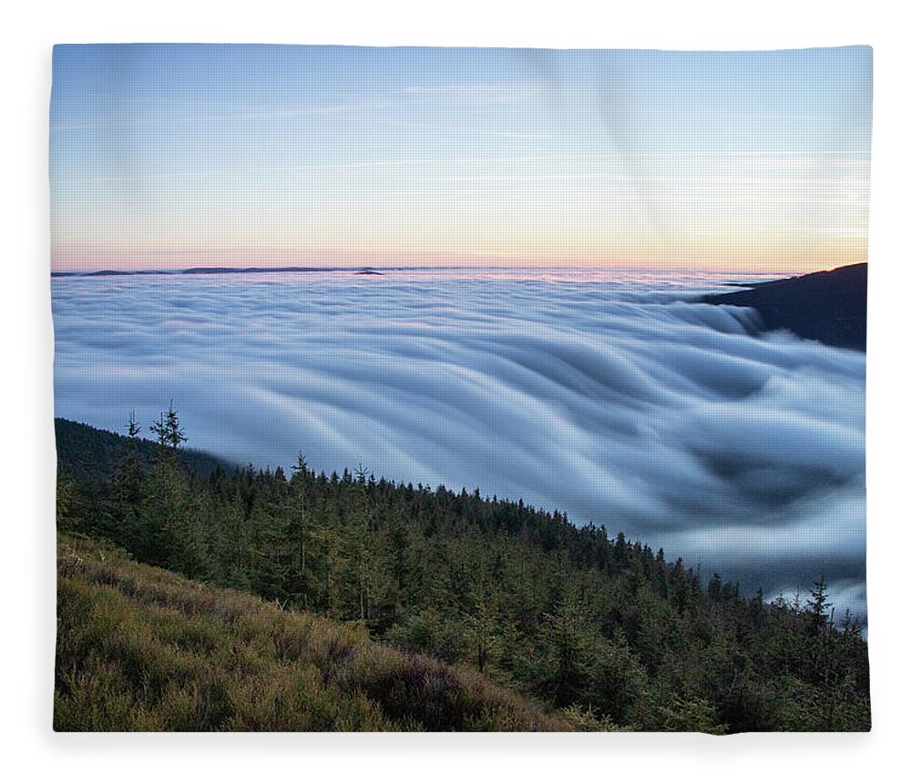 Courage Fleece Blanket featuring the photograph Sunset with floating blue waves of clouds by Vaclav Sonnek
