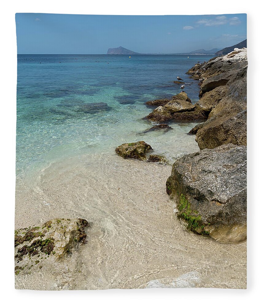Mediterranean Fleece Blanket featuring the photograph Turquoise blue sea water and rocks in Calpe 1 by Adriana Mueller