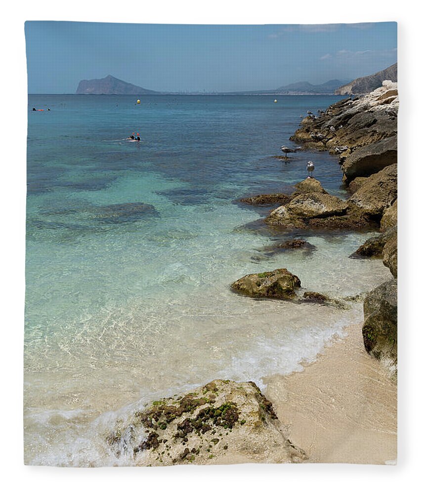 Mediterranean Fleece Blanket featuring the photograph Turquoise blue sea water and rocks in Calpe 3 by Adriana Mueller