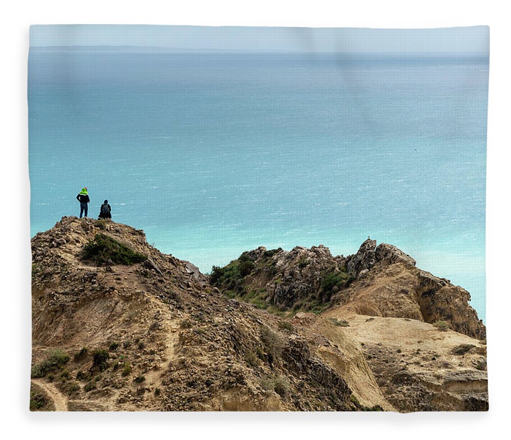 Sea Fleece Blanket featuring the photograph Standing at the edge of a cliff enjoying sea. People hiking outdoors by Michalakis Ppalis