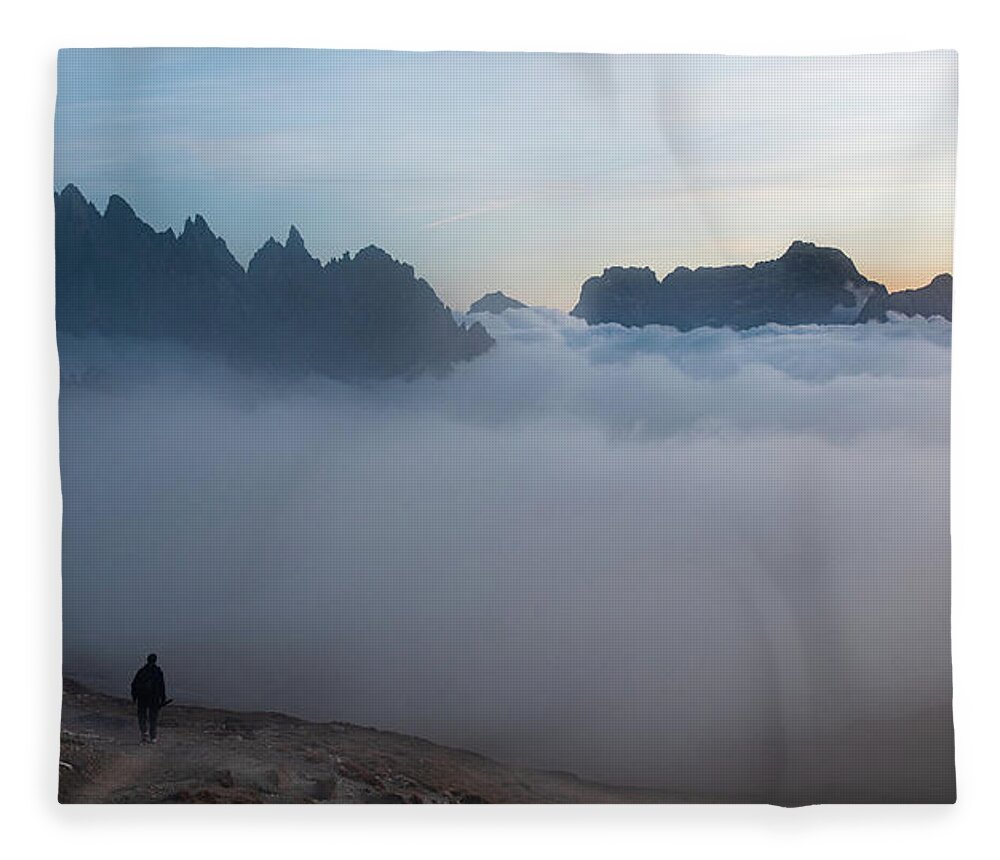 Italian Alps Fleece Blanket featuring the photograph Unrecognized man trekking at the hiking path at Tre Cime in South Tyrol in Italy. by Michalakis Ppalis