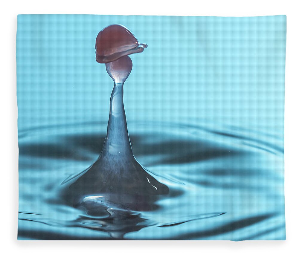 Waterdrop Fleece Blanket featuring the photograph Water drop falling onto column of water by Steven Heap